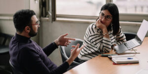 man and woman talking at work